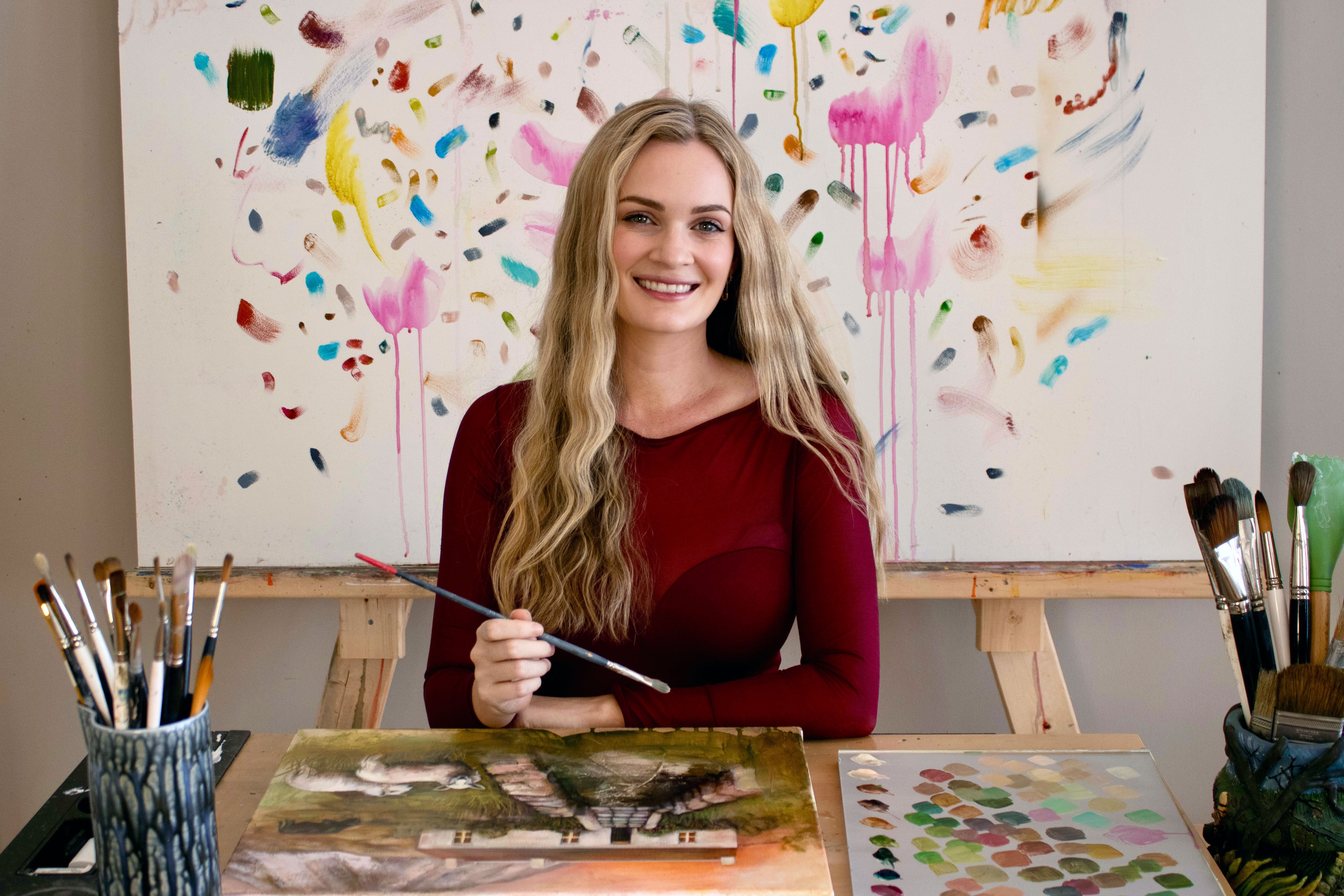 Kristen Bitar painting an oil painting in her Raleigh NC art studio